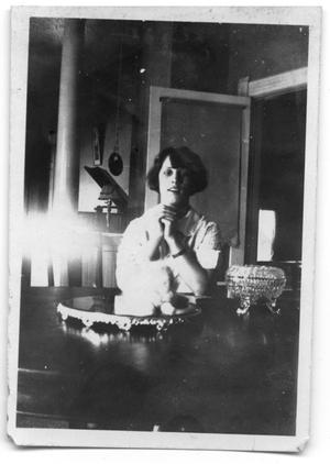 Unidentified woman sitting at a table