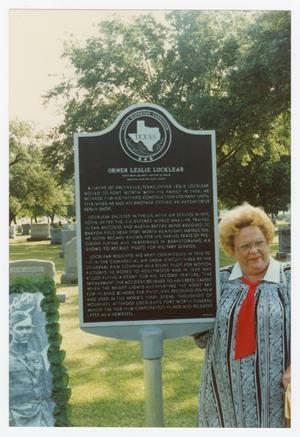 [Woman with historical marker]