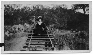 Neely Scrivner sitting on wooden steps on the side of a hill