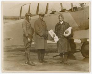 Primary view of object titled '[Ormer Locklear, Fred Rochester, and Lt. Ralph Diggins by plane]'.