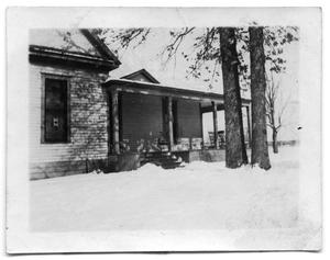 Portrait of the Scrivner house covered in snow