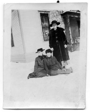 Portrait of three women in the snow outside a house