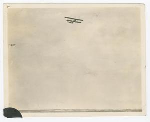 Primary view of object titled '[Biplane over field]'.