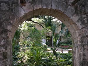 Grounds of the Alamo through an archway