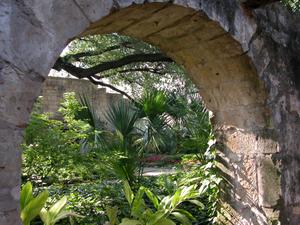 Grounds of the Alamo through an archway