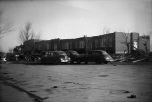 [Photograph of School, Cars, and Debris]
