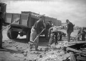 [Photograph of Men Cleaning Tornado Debris]