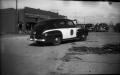Photograph: [Photograph of Police Car and Debris]