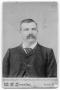 Photograph: Mustached Man in Suit and Tie