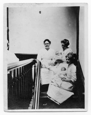 Three Nurses Holding Babies