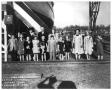 Photograph: Group of people at the Christening of a ship