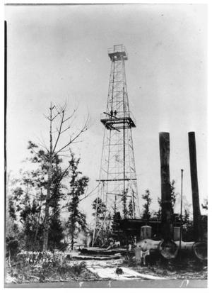 A derrick and steam engine at the Deweyville oil well