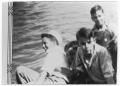 Photograph: Four boys in a boat on the water