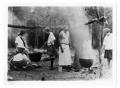 Photograph: [Camp fire girls cooking at camp]
