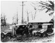 Photograph: [Two cars stalled in mud]