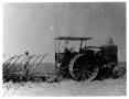 Photograph: [Two Men Running a Tractor in a Field]