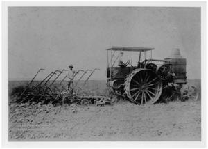 Primary view of object titled '[Two Men Running a Tractor in a Field]'.