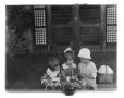 Photograph: [Three children interacting with each other]
