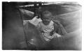 Photograph: [Child in wicker carriage]