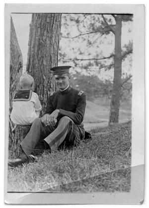 Primary view of object titled '[Man sitting next to a child]'.