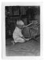 Photograph: [Boy using a tool on a chair]