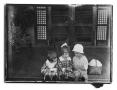 Photograph: [Three children sitting on a porch]
