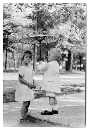 Primary view of object titled '[Boy holding a small umbrella]'.