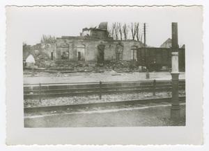 Primary view of object titled '[Photograph of Ruined Building Across Railroad Tracks]'.