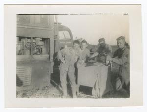 [Four Soldiers Standing Near a Truck]