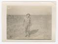 Photograph: [Soldier Standing in a Dusty Field]