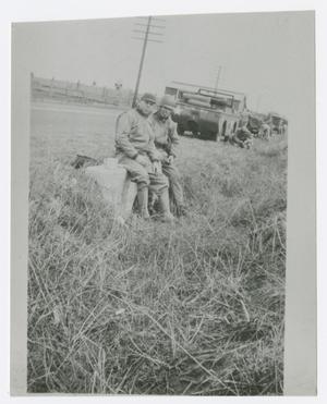 [Photograph of Two Soldiers Sitting Near a Jeep]
