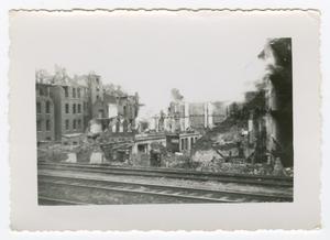 [Photograph of Destroyed Buildings Behind Railroad Tracks]