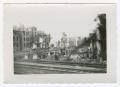 Primary view of [Photograph of Destroyed Buildings Behind Railroad Tracks]