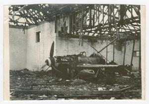 [Photograph of a Damaged Airplane in a Ruin]