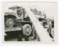 Photograph: [Soldier in Truck on a Flatbed Vehicle Hauler]