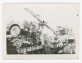 Photograph: [Soldier Securing Jeeps on a Hauler]