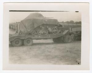 Primary view of object titled '[Photograph of Covered Locomotive on Truck Bed]'.