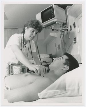Primary view of object titled '[Woman Standing Over Patient]'.