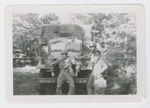 [Three Soldiers In Front of Army Vehicle]