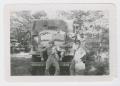 Photograph: [Three Soldiers In Front of Army Vehicle]