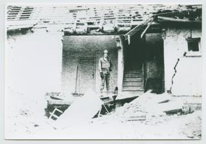 Primary view of object titled '[Henry Taylor Among Debris]'.