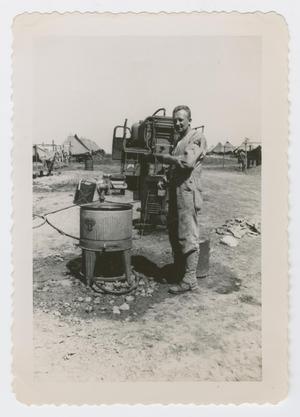 Primary view of object titled '[Soldier at Washing Machine]'.