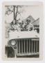 Photograph: [Men and Women in Jeep]