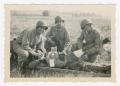 Photograph: [Soldiers Treating a Patient on a Litter]