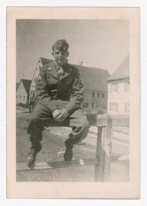 Primary view of object titled '[Howard Fay Sitting on a Bridge Rail]'.
