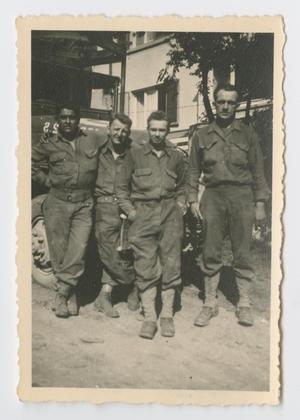 [Four Soldiers Posing Together by a Truck]