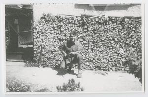 Primary view of object titled '[Soldier Kneeling in Front of a Woodpile]'.