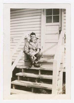 Primary view of object titled '[Robert Ariniello Sitting at the Top of Barracks Steps]'.
