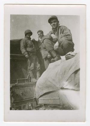 [Three Soldiers on a Vehicle]