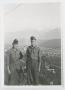 Photograph: [Two Soldiers on Bluff Overlooking a Town]